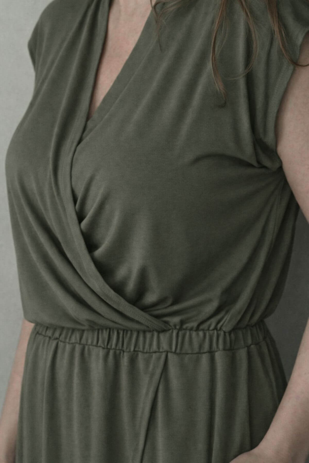 Green nursing dress worn by a person against a neutral background