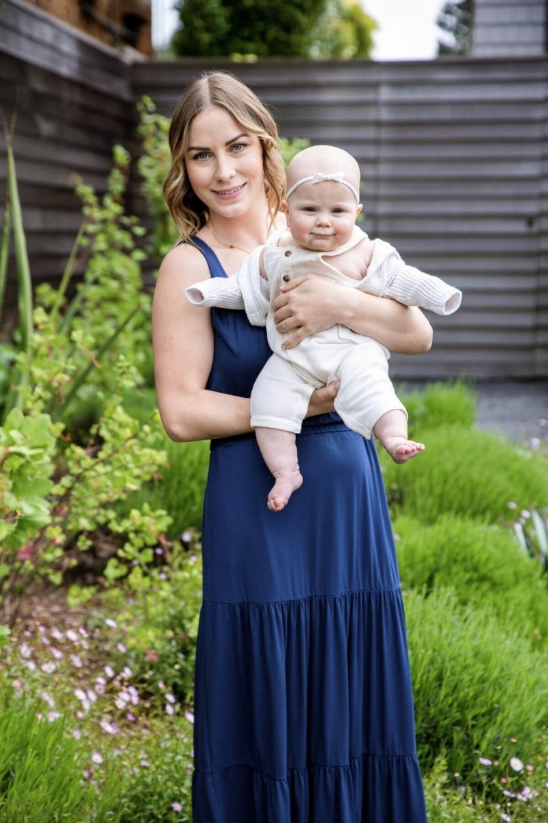 Lark Maternity & Nursing Maxi Dress - Indigo - Simple Wishes - full body front on postpartum model with baby lifestyle image