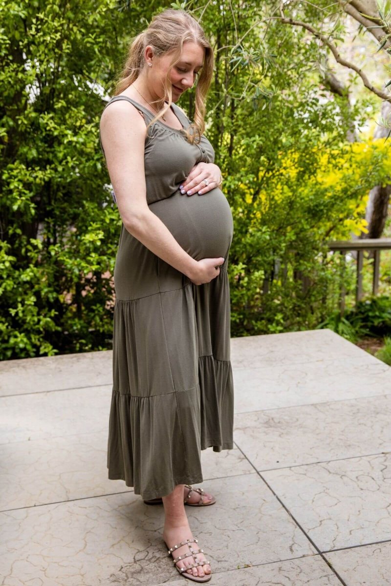Lark Maternity and Nursing Dress in Olive Green front view pregnant model standing