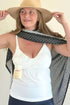 SuperMom® Silhouette Nursing & Pumping Seamless Tank - Pearl - Half Body front view with one full breast pump bottle inserted in tank. Model is styling with a hat and the Navy Dot Haven Nursing Cover
