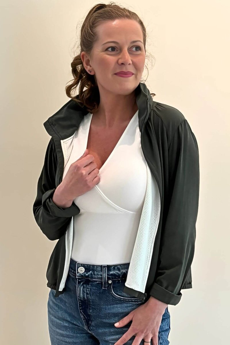 Simple Nursing Tank Pearl standing lifestyle styled with a green jacket