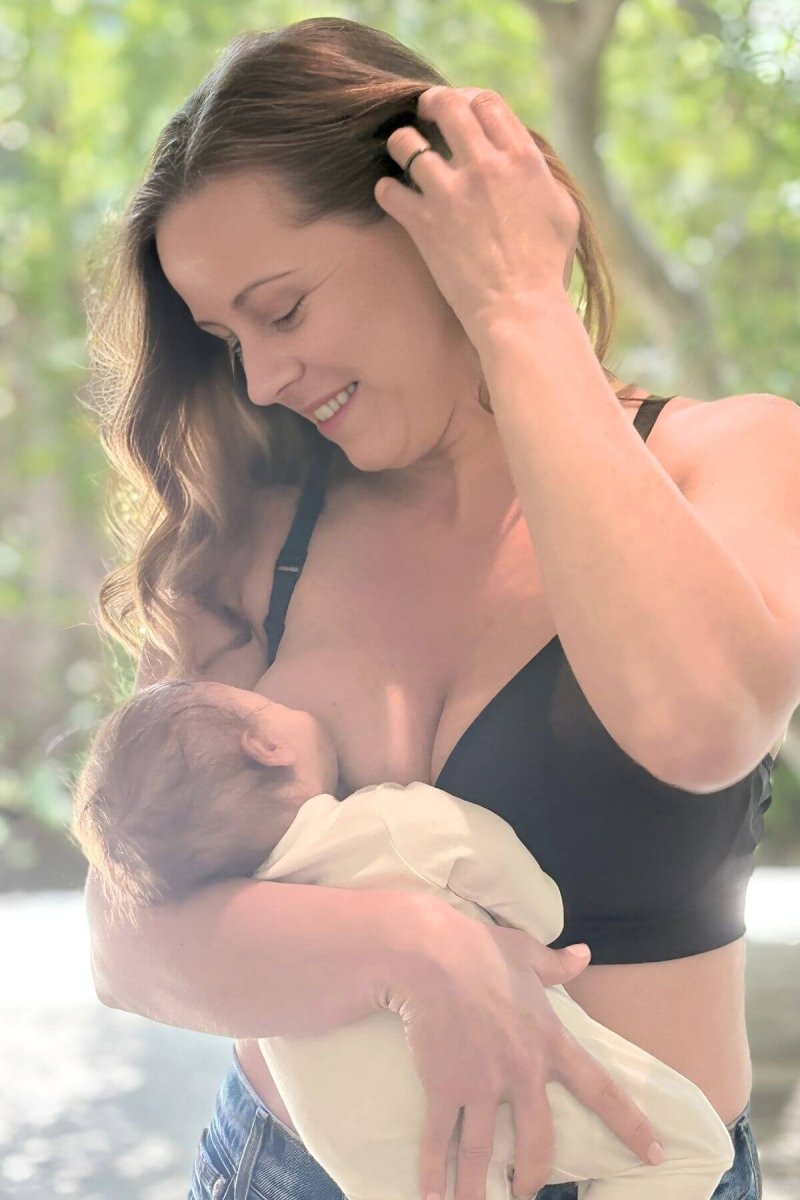 SuperMom® Silhouette Nursing & Pumping Seamless Bra - Fixed Pads - Simple Wishes - Midnight - front view lifestyle of mom breastfeeding