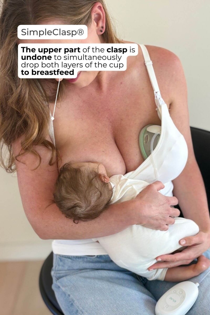 SuperMom Silhouette Nursing & Pumping Seamless Tank - Pearl - Infographic showing model breastfeeding while the tank is supporting a wearable in bra breast pump. Text overlay says "SimpleClasp® - The upper part of the clasp is undone to simultaneously drop both layers of the cup to breastfeed".