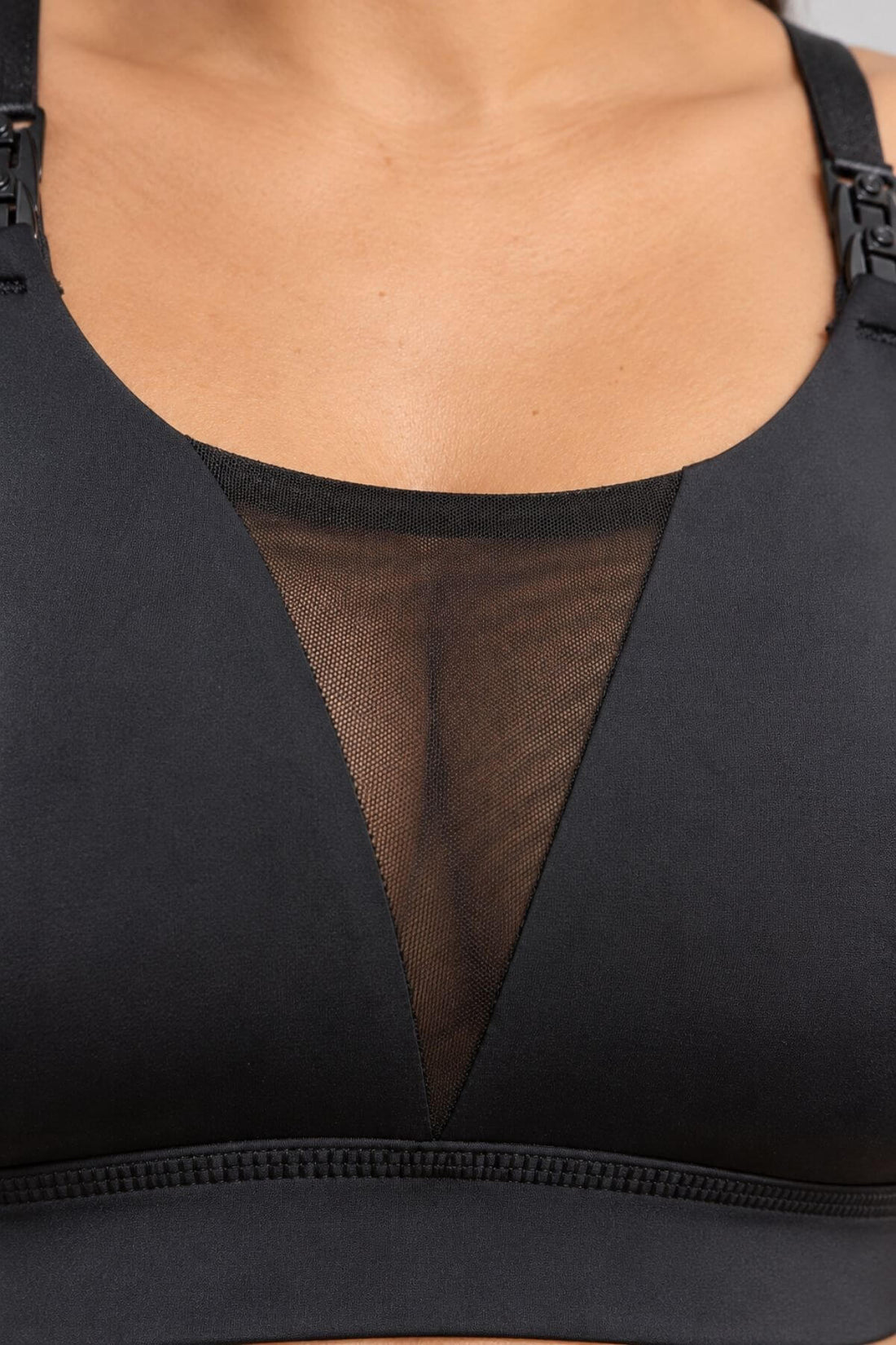 Close-up of the Supermom V mesh tank style nursing and hands free pumping sports bra with the sheer mesh V-neck panel, shown on a model.