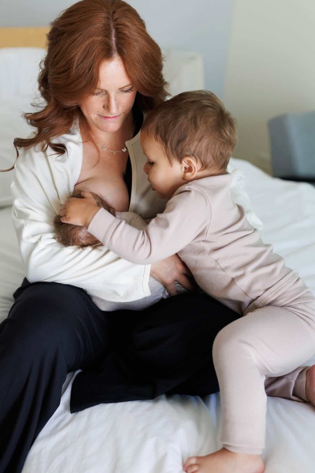 Aspen Breastfeeding Fleece Pullover front view deep v-neck with mom breastfeeding baby and toddler