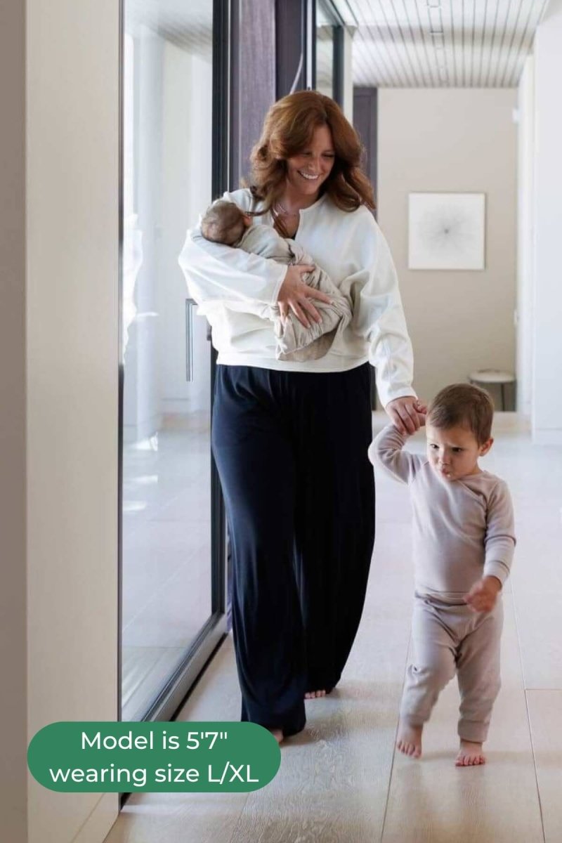 Aspen Breastfeeding Fleece Pullover front view deep v-neck walking down hallway with baby and toddler