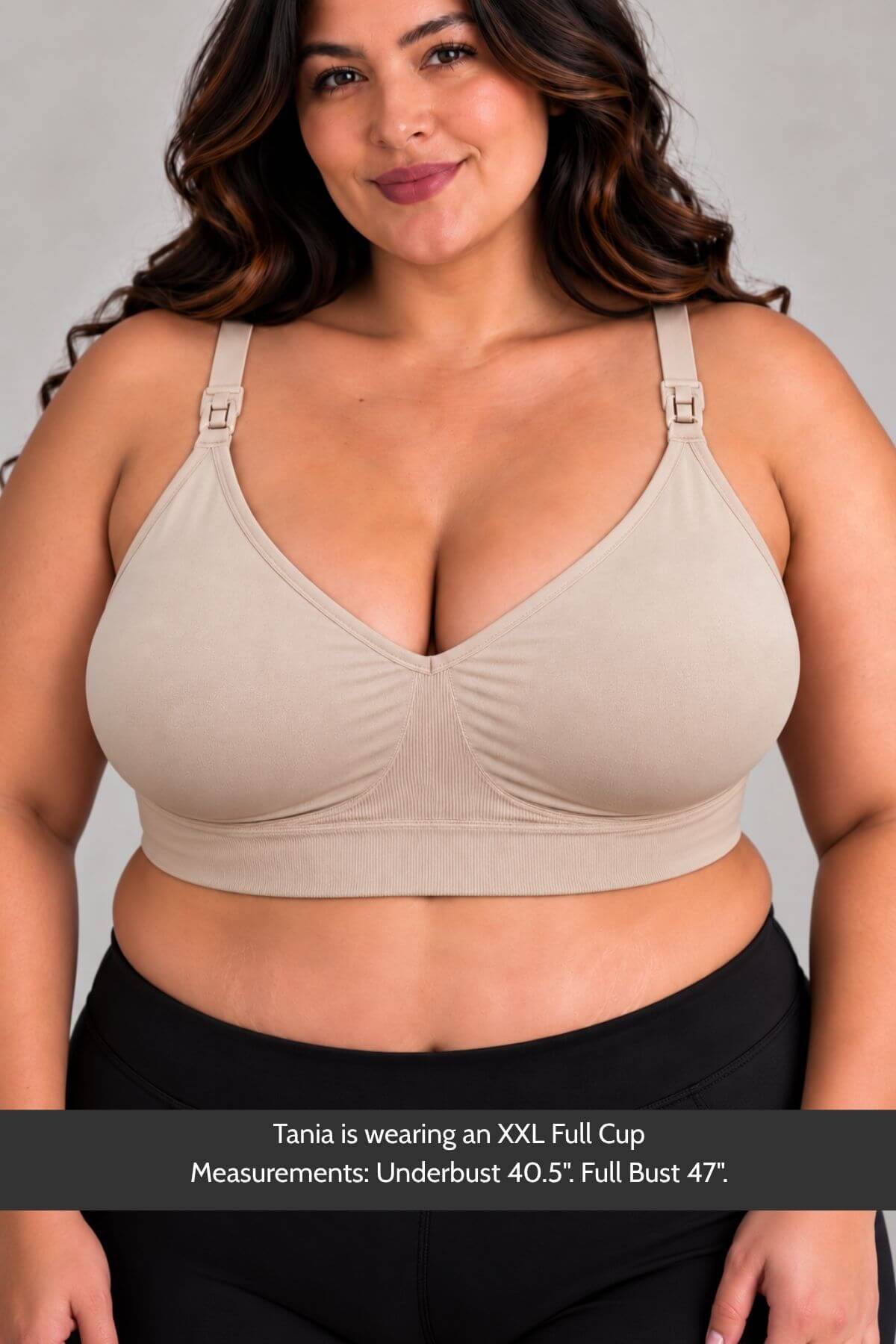 A plus-size woman wearing the Stages Maternity, Nursing, Wearable Pump & Everyday Bra in Sunkissed Rose with front adjustable shoulder straps, paired with black bottoms. A text banner at the bottom provides her full cup sizing information.
