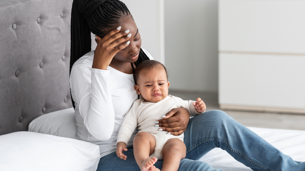 Exhausted New Mom Holding Crying Baby