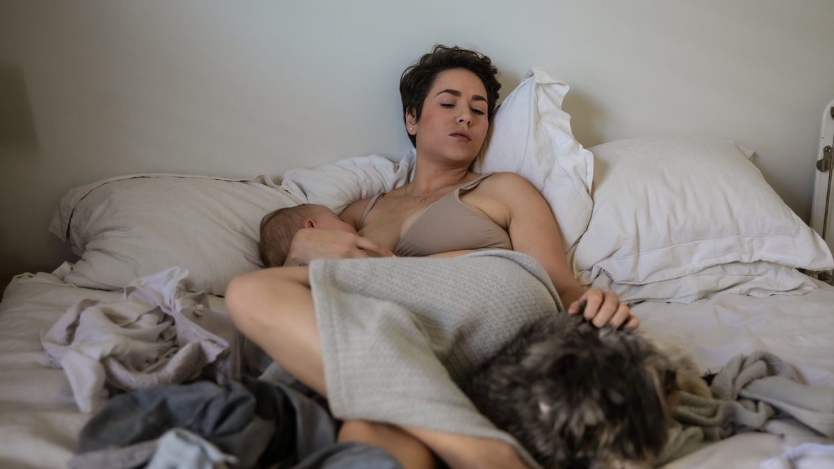 Mom Breastfeeding Newborn In Nursing Bra