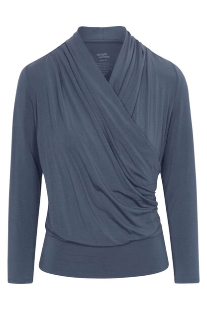 A slate blue long-sleeve wrap top with a draped, asymmetrical crossover front, shown on a plain white background.