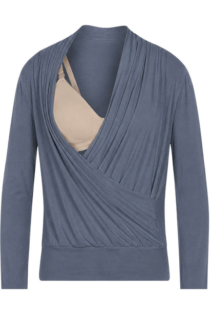 A slate blue long-sleeve wrap top styled over a beige bralette, presented on a clean white background.