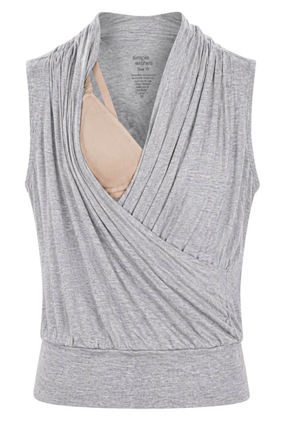 A light gray heathered sleeveless wrap-style top with a draped cowl neckline, shown on a white background with a beige bra underneath for support..