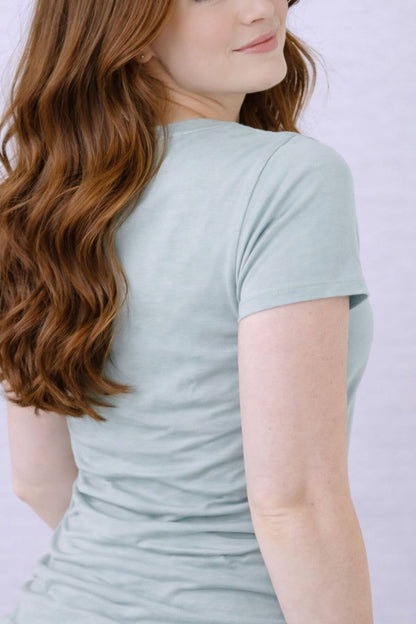 Woman wearing a light gray blue nursing top back view