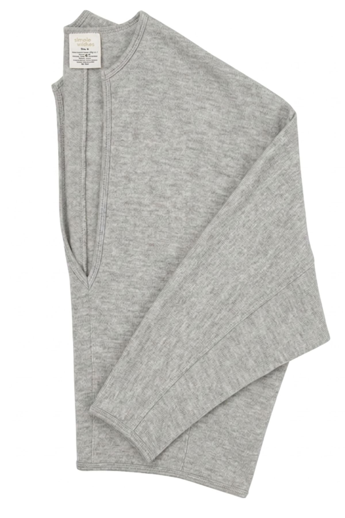 A folded light gray heather knit long-sleeve top with a split neckline, shown on a plain white background.