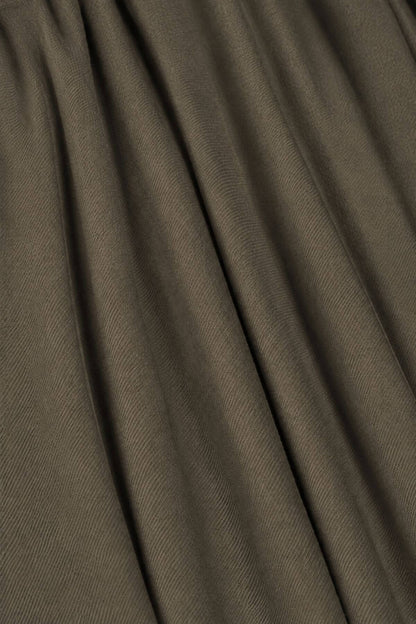 A close-up of draped olive brown fabric with soft folds and a fine textured 
