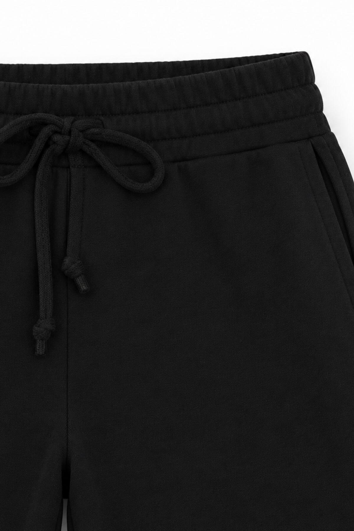Close-up of a black jacket with zippers and buttons on a white background