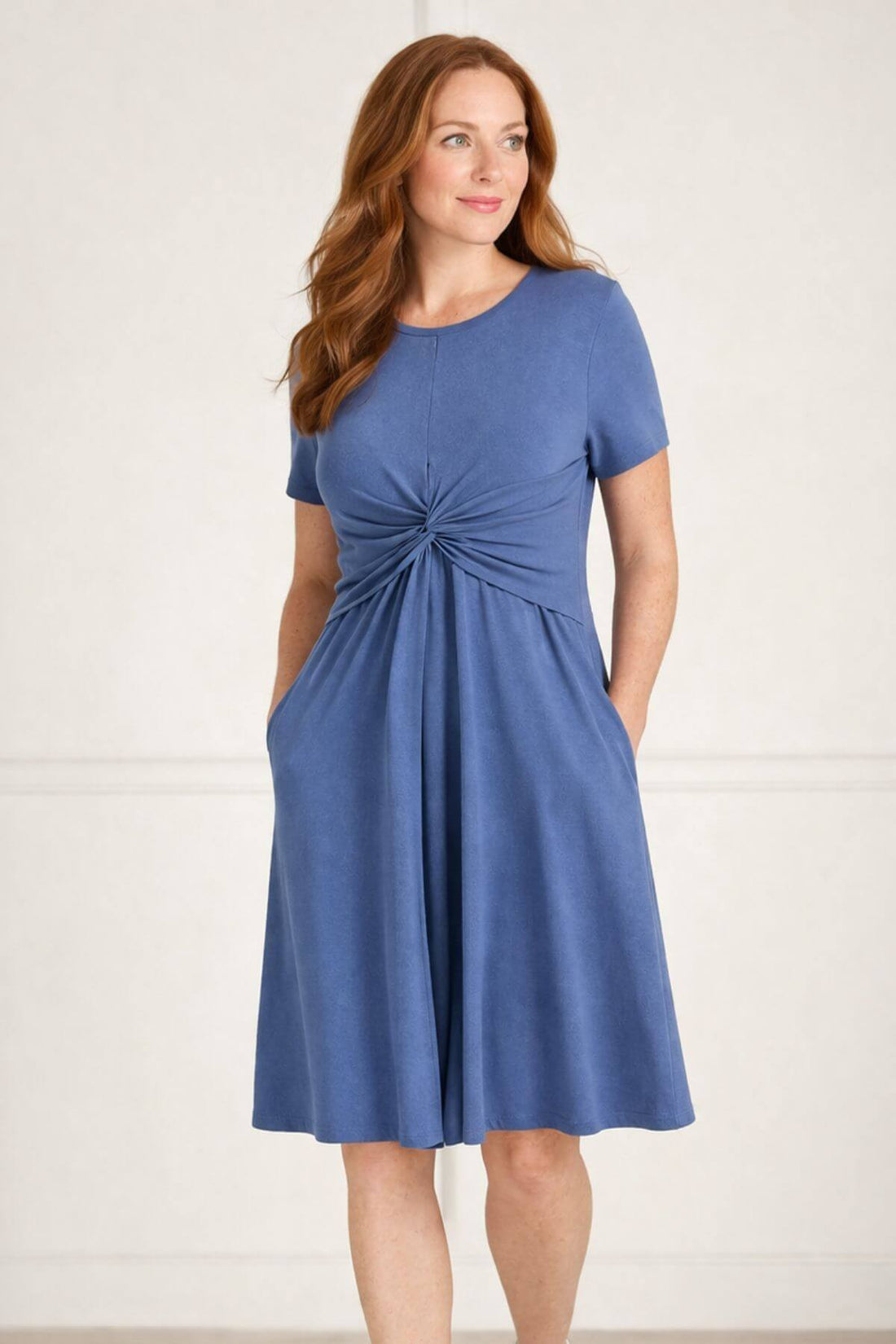 Woman wearing a dark blue nursing dress for breastfeeding with functional pockets front view