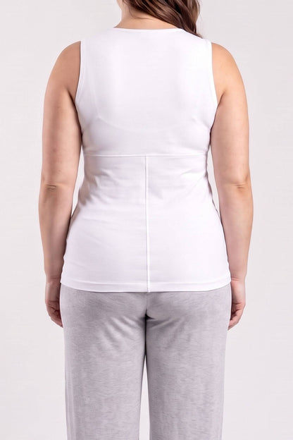 A woman shown from the back wearing a white sleeveless top and light gray sweatpants against a plain light gray studio background.