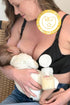 Woman breastfeeding a baby while wearing a hands free pumping and nursing bra that is holding a full bottle  of expressed breastmilk with a visible 2025 babies best award badge in the corner.