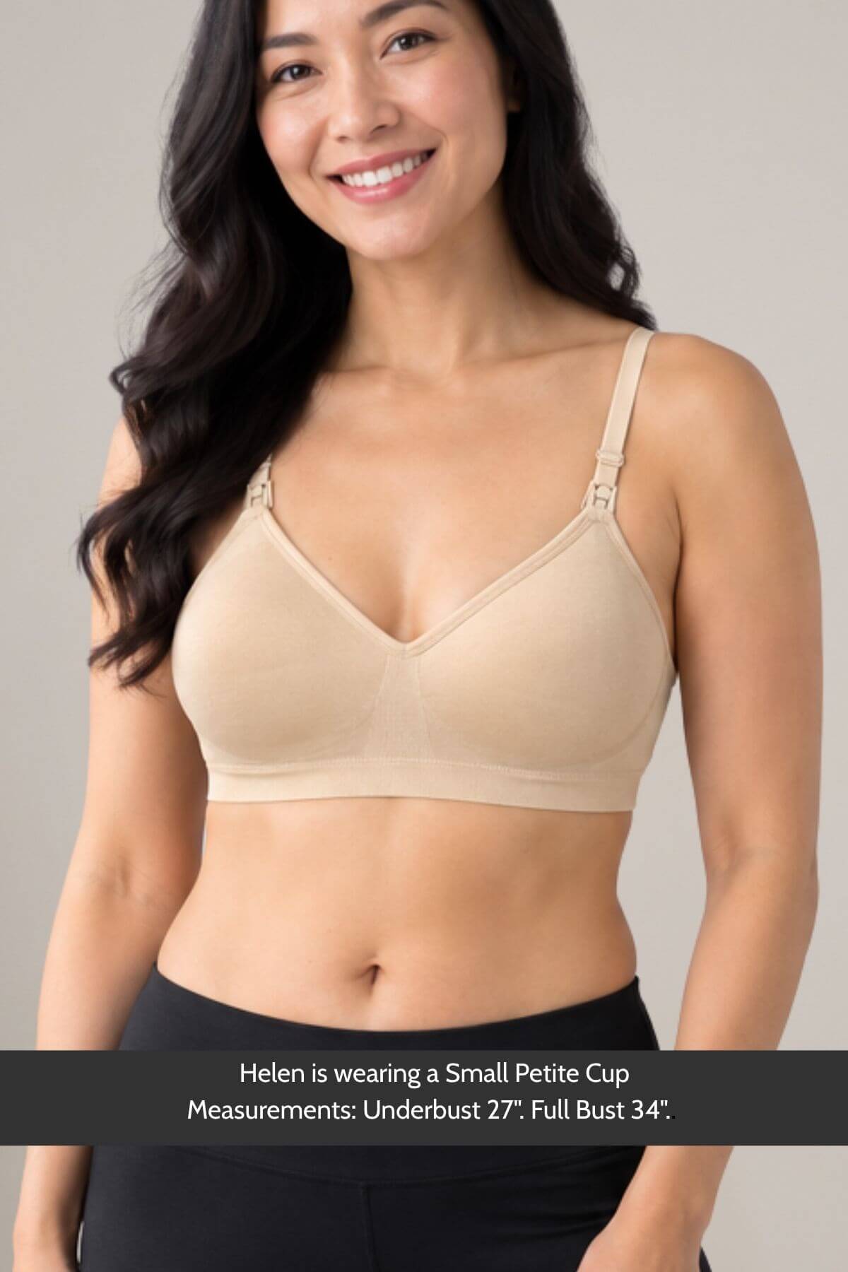 A woman wearing the Stages Maternity, Nursing, Wearable Pump &amp; Everyday Bra in Sunkissed Rose front djustable shoulder straps, shown against a light gray background with a text banner at the bottom detailing her petite cup measurements.
