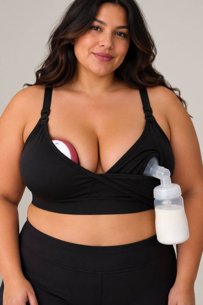 A plus size woman wearing simple wishes supermom silhouette nursing and hands free pumping bra, shown with a breast pump attached to the side and an in bra wearable breast pump supported in the other cup, against a plain light gray background.