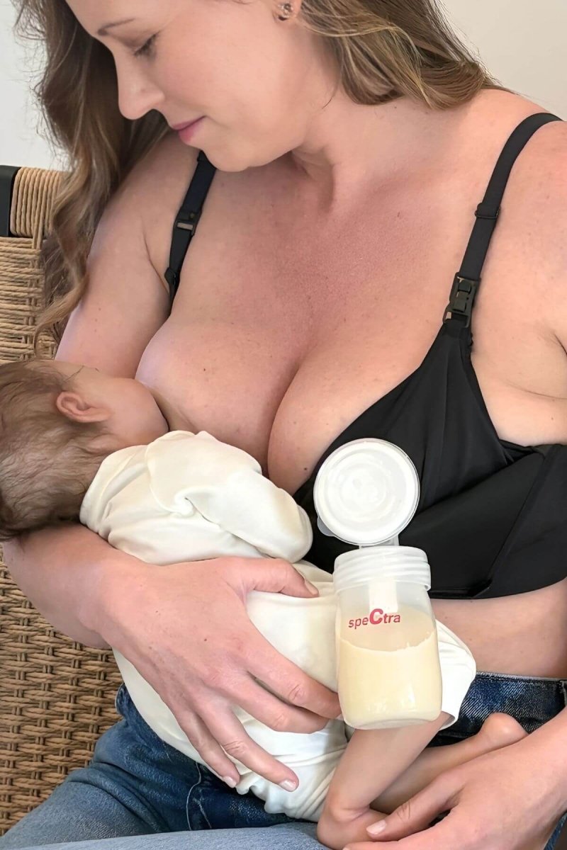 SuperMom® Silhouette Nursing &amp; Pumping Seamless Bra - Fixed Pads - Simple Wishes - Midnight - front view breastfeeding while supporting a single breast pump