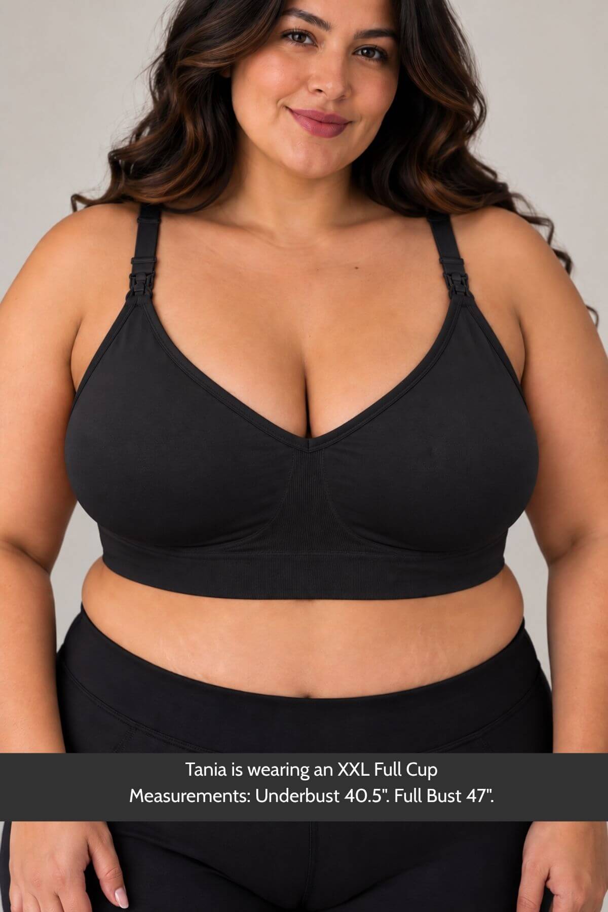 A plus-size woman wearing simple wishes silhouette nursing &amp; hands free pumping bra and black bottoms, shown from the chest down against a light gray studio background. A text banner at the bottom reads: &