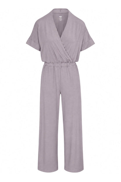 A light lavender-gray short-sleeve wrap jumpsuit with a tie waist and wide legs, shown against a plain white background.