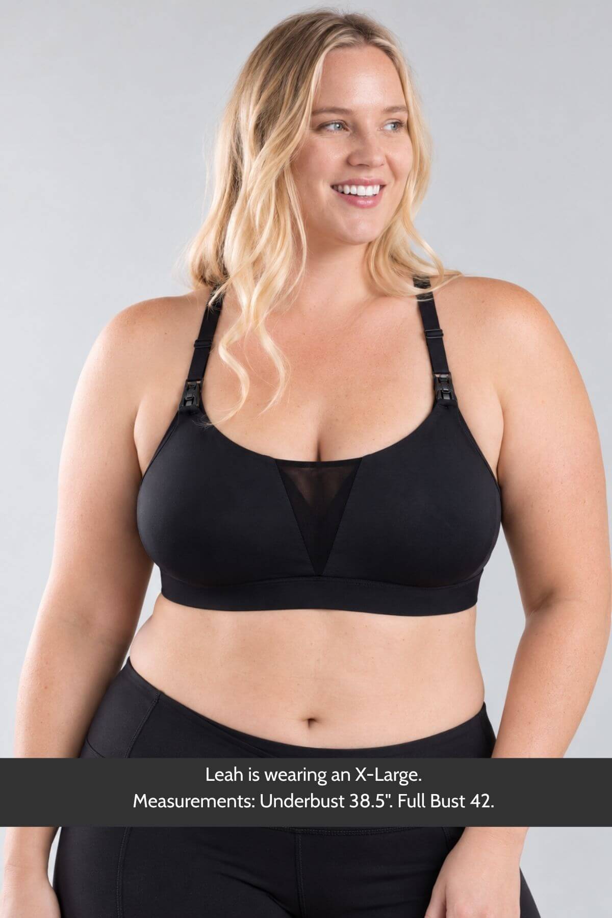 A plus-size blonde model wearing the Supermom V mesh tank style nursing and hands free pumping sports bra and mesh details, shown against a light gray background with a text overlay at the bottom detailing measurements.