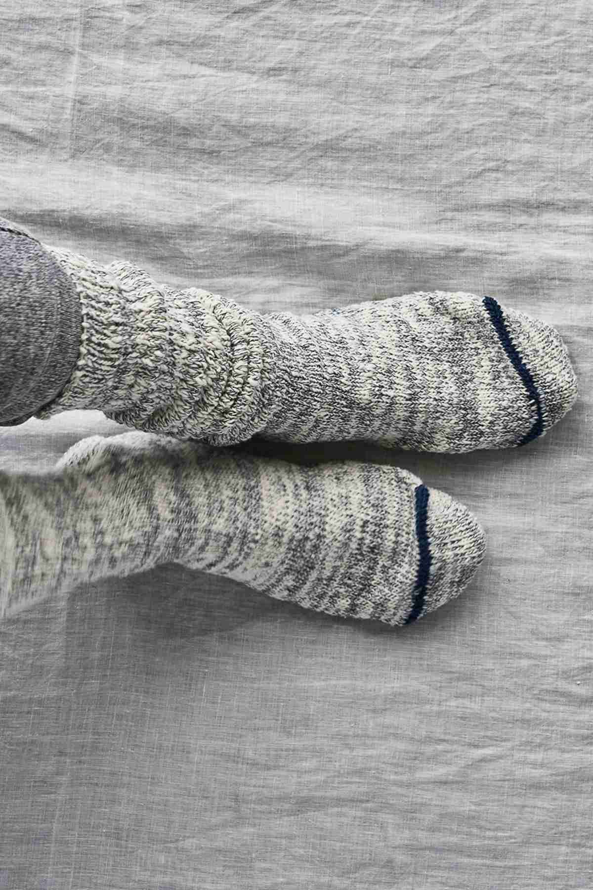 Garabou Indigo Blue socks on gray background 1 pair on feet