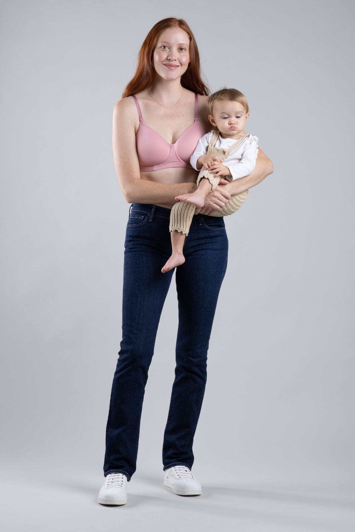Simple Wishes Undercover nursing t-shirt bra with hide the nursing clasp feature in rose pink shown with baby held in arms