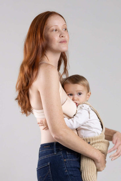 Simple Wishes Undercover nursing t-shirt bra in sunkissed rose with hide the nursing clasp feature shown with baby breastfeeding
