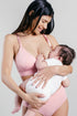 SuperMom Skin-to-Skin Nursing & Pumping Bra front view model breastfeeding baby in color rose pink
